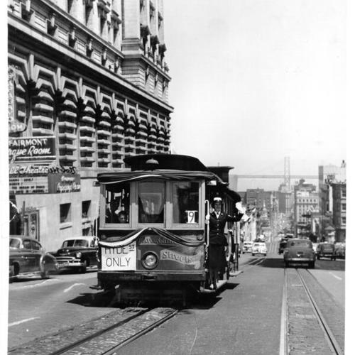 [Wave Yeoman Joan Mackie riding on a California Street cable car]
