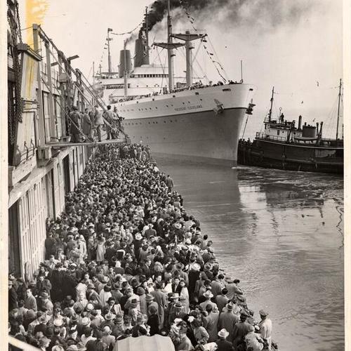 [People waiting at harbor as ship "President Cleveland" arrives]
