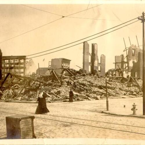 [Wreckage of buildings destroyed in the earthquake and fire of 1906, with the ruins of Hale's Department Store in the background]