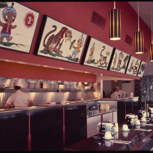 Sambo's Restaurant counter seating with mascot and tiger art hanging on wall