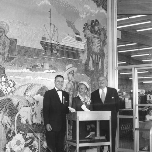 [Mr. and Mrs. Quentin Reynolds standing with John Garth outside the Marina Safeway on opening day]