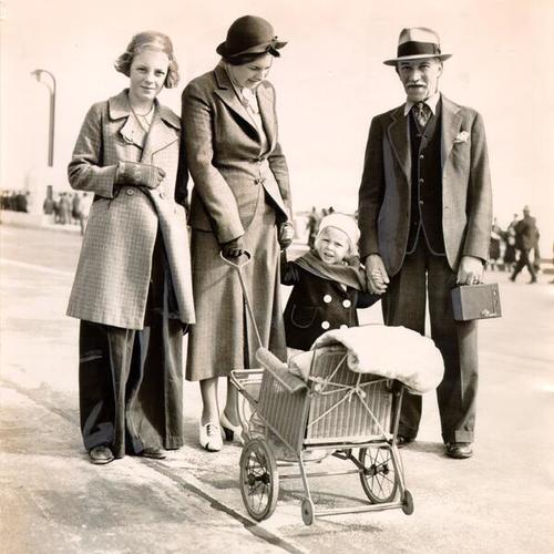 [Family taking first baby carriage across the Golden Gate Bridge on Pedestrian Day]