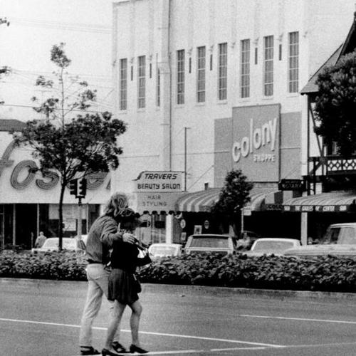 [Two people crossing Geary Boulevard in the Richmond District]