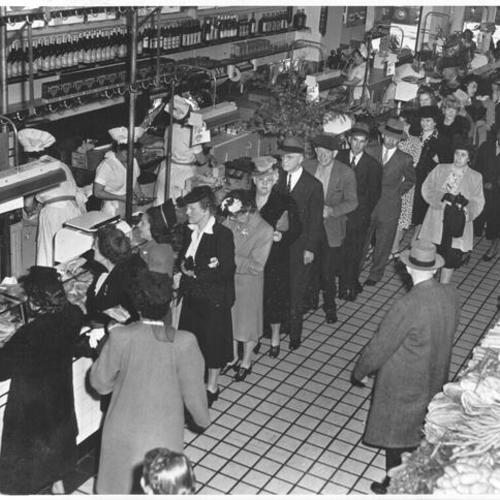 [People lined up to buy ham and bacon at Hale Brothers Market]
