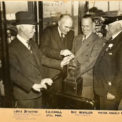 [Louis Byington, E.G. Cahill, Ray Schiller, Mayor Angelo Rossi, celebrating L car line extension]
