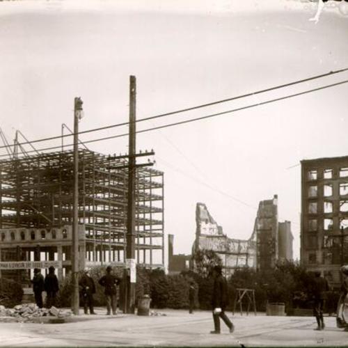 [Construction of the Newman & Levinson Dry Goods building, surrounded by ruins of other buildings destroyed in the earthquake and fire of April 18, 1906]
