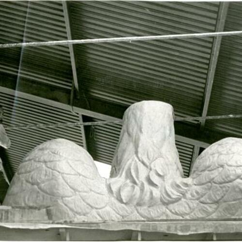 [Manuel Palos in his studio on scaffold carving an eagle's head for Pacific Telephone Bell Building]