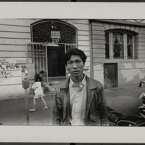 Tenderloin resident Nguyen Quoc Doanh standing outside building at 237 Leavenworth Street