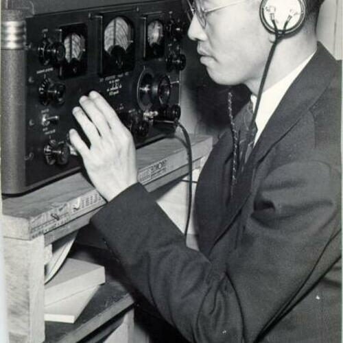 [Liu Pei Chi listening to a short wave radio in Chinatown]