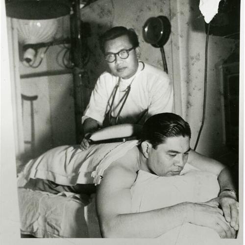 [Dr. Roberto at his office with patient]