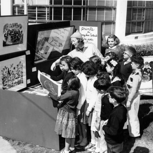 [Artist Emmy Lou Packard and Hillwood School students in front of the Maritmime Museum at Aquatic Park]