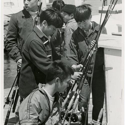 [Group of boys with fishing rods at Yacht Harbor, Marina District]
