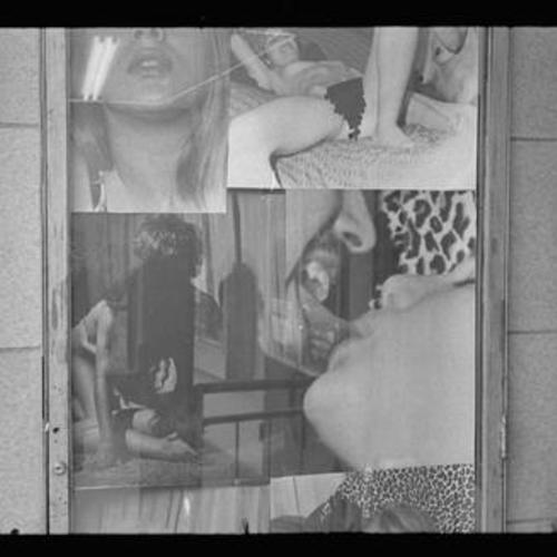 Exterior view of Gayety Theatre display window with photo collage of people in sexual poses