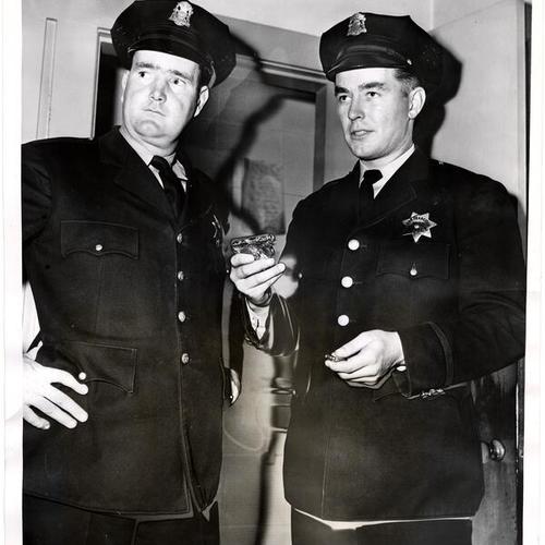 [Officers Tomothy Casey and John ("Jack") Webb at Northern Station, holding a gun taken from burglar]