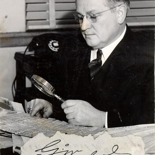 [Judge Elmer E. Robinson inspecting his collection of Americana]