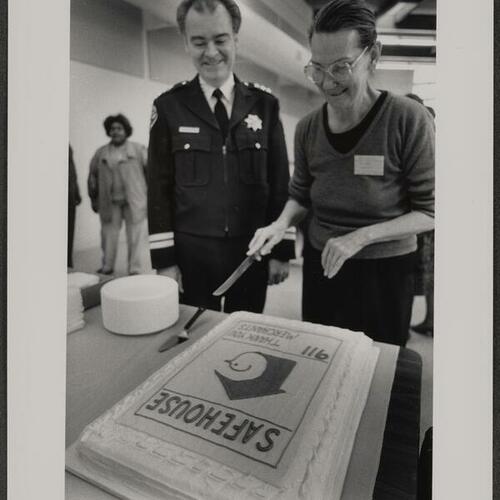 Police Chief Frank Jordan with Flora Harvey cutting cake for Safehouse project's sixth anniversary celebration