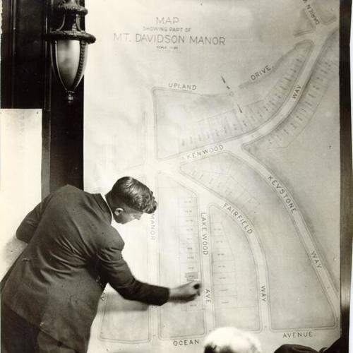 [Man standing in front of a large map of the Mount Davidson area]