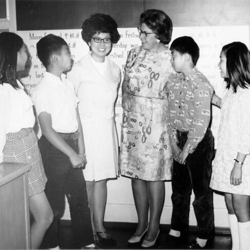 [Miss Anna Wong with four students and another adult at Garfield School]