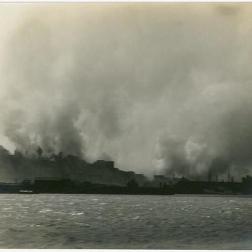 [View, from the bay, of Telegraph Hill and Lombard Street burning]