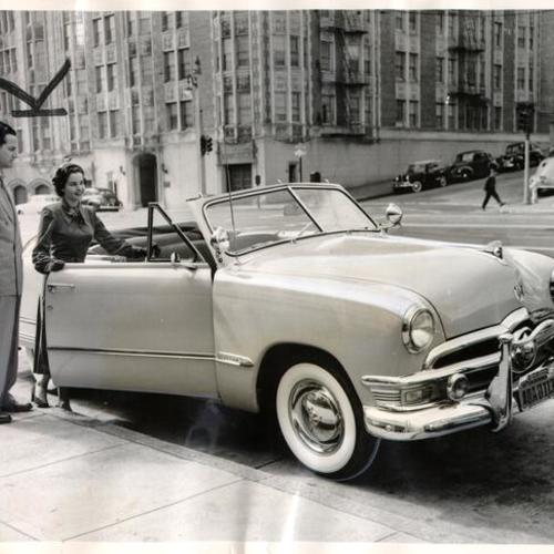 [Elizabeth McGee standing next to a Ford convertible loaned to her by Bud Anderson of Berl Berry Ford dealership]