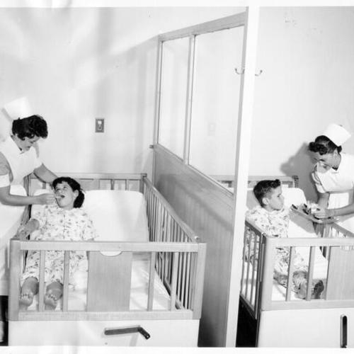 [Student nurses treating children at St. Luke's Hospital]