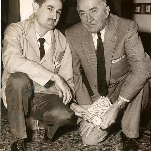 [Managers of Tommy's Joynt Orlando Velez and Fred Quick with money found on the floor of the restaurant]
