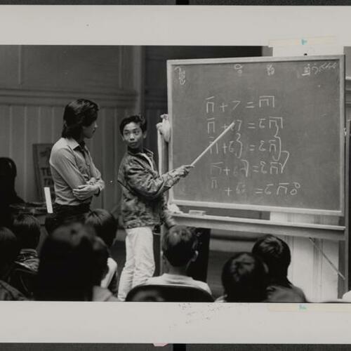 Sitha Sum teaching Phit Sna (12 years old) Cambodian phonetics at Cambodian language school at Cadillac Hotel