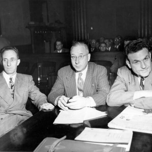 [Harry Bridges (L), Henry Schmidt (C) and J. R. Robertson, ILWU officials charged with perjury and on trial here are shown in a meditative mood during a court recess]