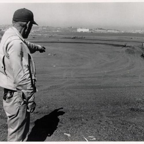 [Surveyor Irwin B. Williams pointing to the pitchers mound]