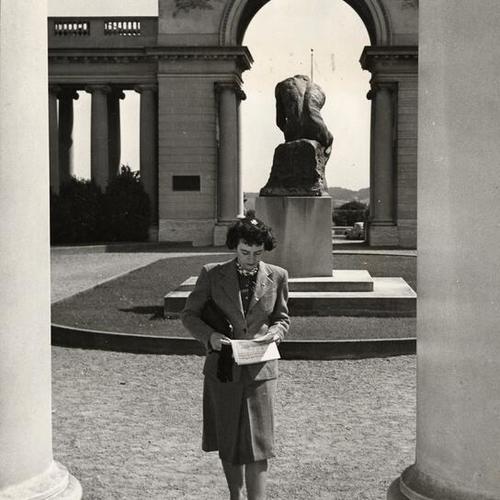 [Woman walking through courtyard at the Palace of the Legion of Honor]