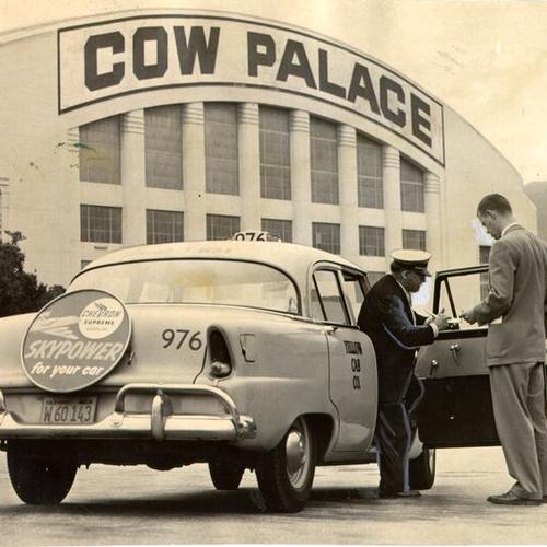 [San Francisco News reporter George Murphy paying cab driver Nicholas Liuzza for a ride from the St. Francis Hotel to the Cow Palace]
