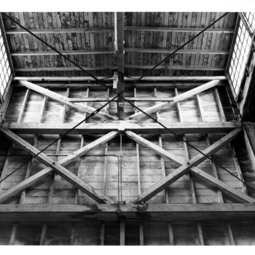[Interior view of the east wall and roof of Pier 16 shed]