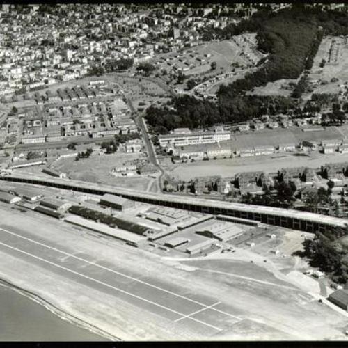 [Aerial view of the Presidio view of the Marina approach to the Golden Gate Bridge]
