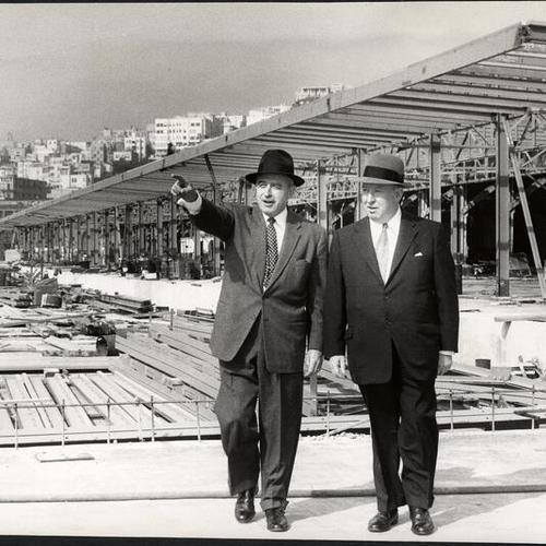 [Port Director Charles Tait and Winston J. Jones, executive vice president of Pacific Transport Line, surveying a renovation project at Piers 15 and 17]