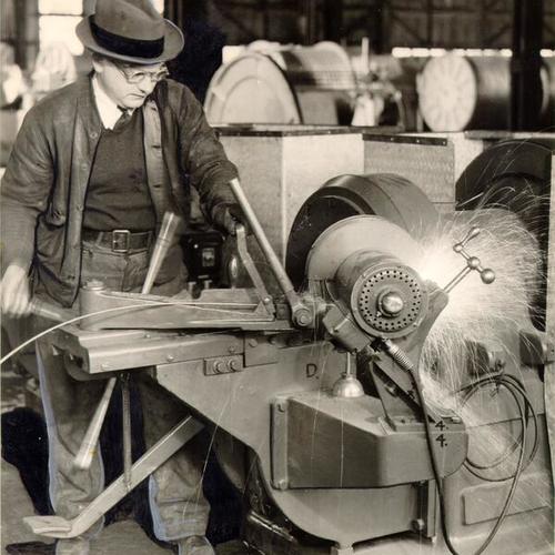 [Worker spinning wire for cable to be used on the San Francisco-Oakland Bay Bridge]