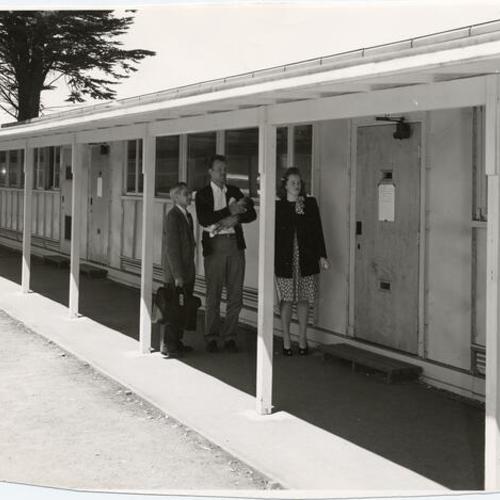 [Three people standing outside of new classrooms at the University of San Francisco]