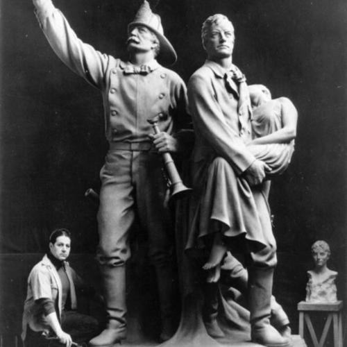 [Sculptor Haig Patigian posing with his bronze statue commemorating the Volunteer Fire Department of 1849 - 1866]