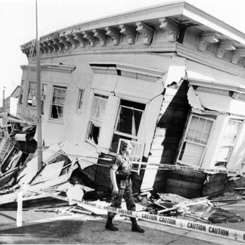 [Soldier standing in front of a Marina District building destroyed in the October 17, 1989 Loma Prieta earthquake]