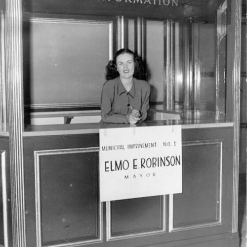 [Catherine Coleman standing in an information booth in City Hall]