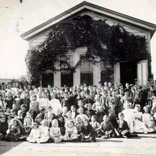 [Group of children posing in front of unknown structure in Visitacion Valley]