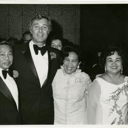 [George Moscone standing between Max Peralta, Annie Abenojar and Mrs. Max Peralta]