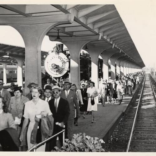 [Commuters on platform at Southern Pacific terminal]