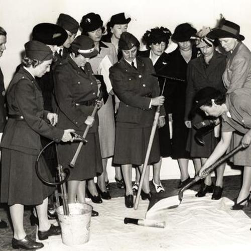 [American Women's Voluntary Services (AWVS) instructors showing ways to put out fires before they get a good start]