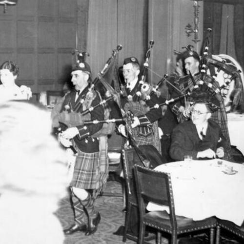 [Bagpipe players in the Spanish Room at the Mark Hopkins Hotel]