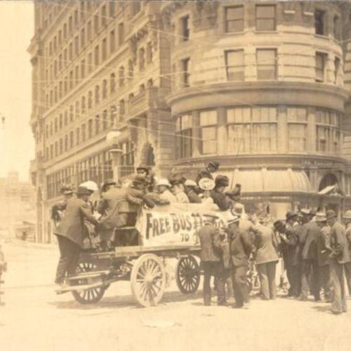 [Group of people on a wagon near the James Flood Building at Market and Powell streets]