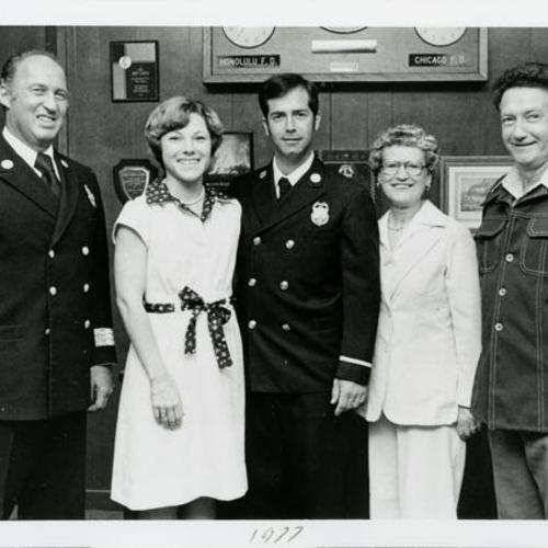 [Portrait of Fire Chief, Fireman plus his three family members]
