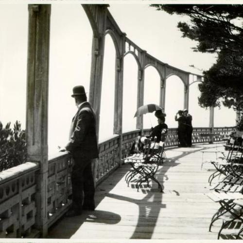 [People looking out at the ocean from Sutro Heights]