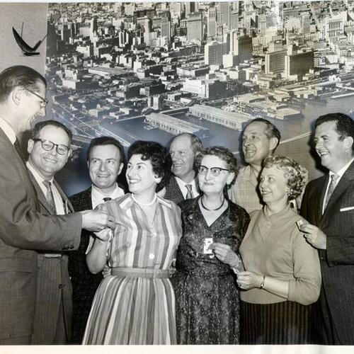 [Ed Sherman, superintendent of Sears, Roebuck & Company's Mission Street store, awarding pins to long-time employees]