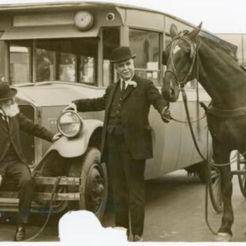 [William J. Dutton and Mayor James Rolph, Jr. standing next to a new public transit bus]