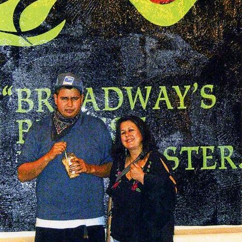 [Alejandro James “A.J.” Trasvina and Nicky Trasvina posing in front of Wicked sign at Orpheum Theater for 21st birthday]